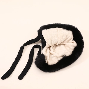 Detail of plush fox ear trapper hat with soft faux fur exterior and warm fleece lining