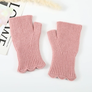 Detail of pink knitted fingerless gloves with scalloped edges and ribbed texture