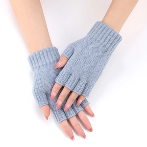 Close-up of light blue knitted fingerless gloves with ribbed cuffs for winter warmth