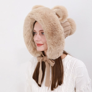 Side view of plush winter fox ear hat in beige brown with cute pom-pom and braided ties