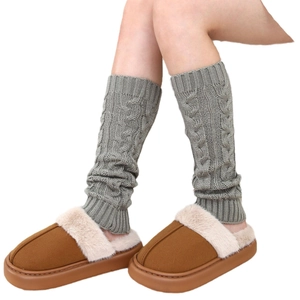 Thick cable knit leg warmers in grey paired with warm brown plush slippers for winter wear
