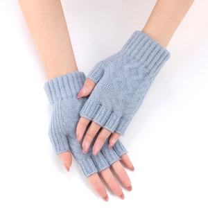 Detailed knit texture of light blue fingerless gloves with elongated ribbed wrist cuffs