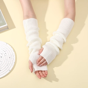 Macro detail of cream ribbed knit texture on long fingerless arm warmers for women
