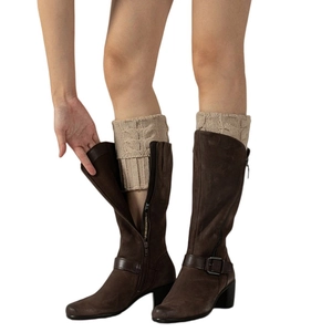 Close-up of cable-knit boot cuffs paired with brown suede boots and side zipper detail