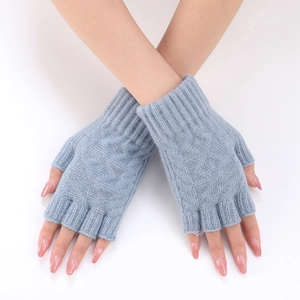 Detail of light blue knit fingerless gloves with ribbed wrist cuffs and soft yarn texture