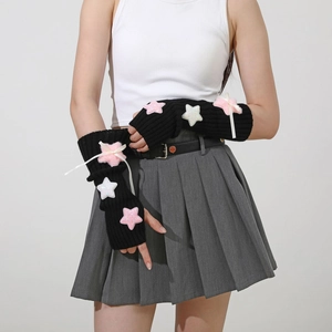 Detail of black Y2K knit arm warmers featuring pink plush stars and white ribbon bows