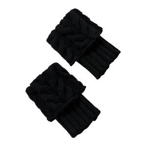 Close-up of black cable-knit leg warmers showing thick knit texture and ribbed cuffs