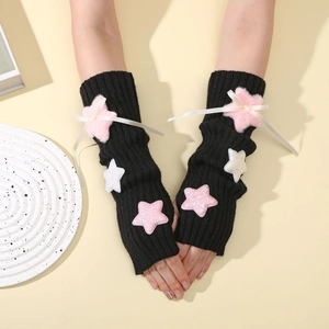 Detail of black ribbed knit arm warmers with plush star patches and white satin bows