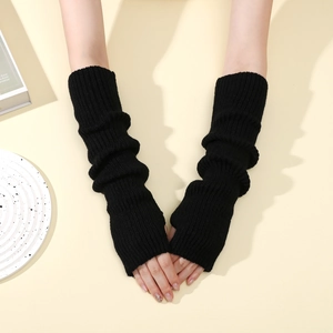 Detail of black ribbed knit arm warmers with thumb holes showing soft textured fabric