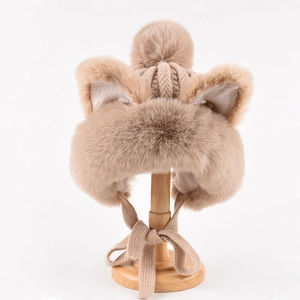 Detail of plush khaki winter hat with furry animal ears and soft knit straps