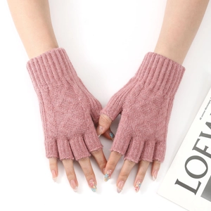 Macro view of pink knitted fingerless gloves with ribbed cuffs and soft wool texture