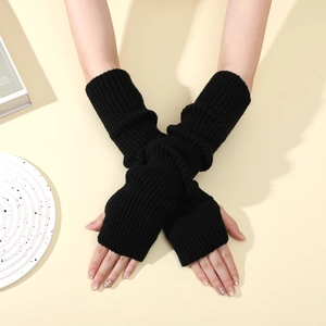 Detail of black ribbed knit fingerless arm warmers showing stretch and texture