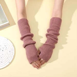 Detailed view of pink knitted arm warmers with fingerless design and ribbed texture