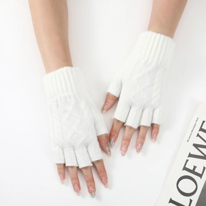 Close-up of white chunky knit texture on fingerless arm warmers for winter fashion