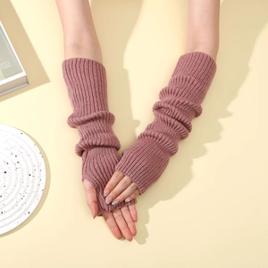 Detail of pink knit arm warmers showing thumb hole design and ribbed texture material