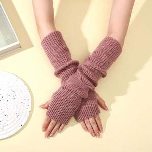 Detail of ribbed knit arm warmers in dusty rose pink with fingerless thumb hole design