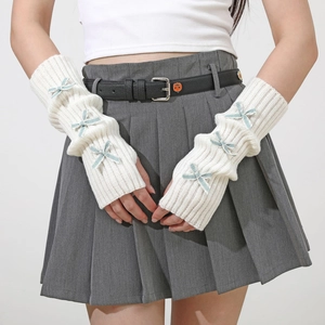 Detailed knit of white arm sleeves with light blue bows and scalloped edge detail