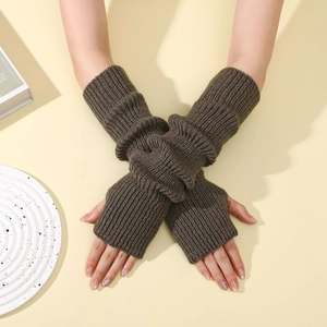Close-up of brown ribbed knit fingerless arm warmers with thumb hole detail