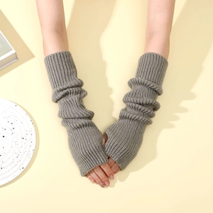 Macro detail of grey knitted arm warmer with ribbed texture and fingerless thumb hole