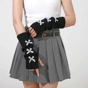 Detail of black knitted arm warmer with light blue lace bows in Y2K aesthetic style
