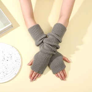 Close-up of grey knit fingerless arm warmers with thick ribbed texture for winter wear