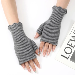 Grey knit fingerless gloves with ruffled edges and vertical ribbed texture for women