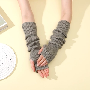 Close-up of grey ribbed knit fingerless gloves with a soft texture and pleated arm warmers