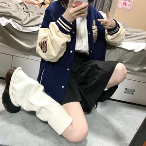 Close-up of Japanese style navy and white striped knit leg warmers for schoolgirl look