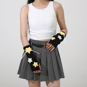 Detail of Y2K knit arm warmers with plush yellow and white stars on black fabric