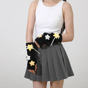 Detail of black knit fingerless sleeves with plush stars and white ribbon bows