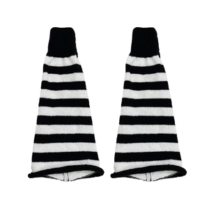 Close-up of black and white striped knitted leg warmers with elastic ribbed cuffs