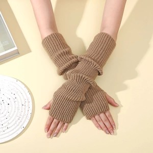 Detailed knit texture of camel fingerless arm warmers on a warm aesthetic background