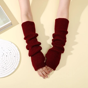 Detail shot of burgundy ribbed knit thumbhole arm warmers with a long textured finish