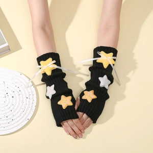 Detail of Y2K knit arm warmers with plush stars and white ribbon bows decoration