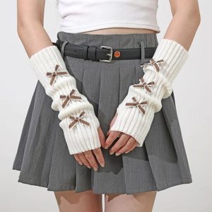 Detail view of white knitted arm warmer featuring vintage plaid bow accents in Y2K style