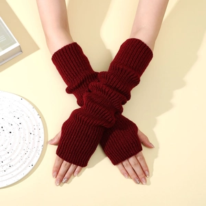 Close-up of ribbed knit fingerless arm warmers in burgundy with thumb hole detail