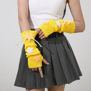 Detail of yellow knit arm warmer with plush stars and elegant cream ribbon bow