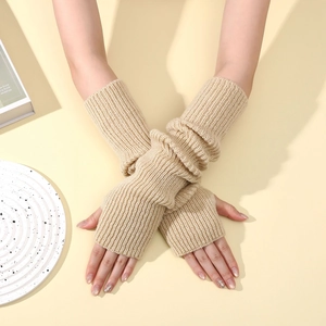 Close-up of knit arm warmers in beige showing ribbed texture and fingerless design