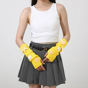 Detail view of yellow knit arm warmers with rib texture and glitter star accents