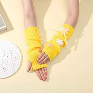 Detail of yellow knit arm warmers featuring white bows and plush star charms