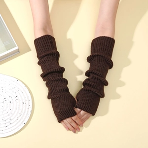Macro detail of dark brown cable knit arm warmers with fingerless design and cozy texture