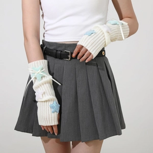 Detail of plush star arm warmers with knit texture and cute ribbon bow accents