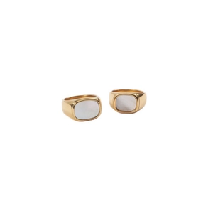 Primer plano de anillos de acero inoxidable chapados en oro 18K con nácar blanco