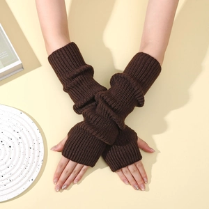 Detail of dark brown knit arm warmers showing thick vertical ribbed texture and fingerless design