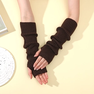 Macro detail of dark brown ribbed knit arm warmer with textured wavy knit pattern