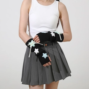 Detail of black knit arm warmers with sequin stars and white ribbon bows for Y2K style