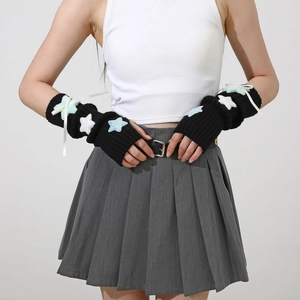 Detail of Y2K black ribbed knit arm warmers with glitter stars and satin bows
