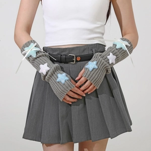 Close-up of knit arm sleeves featuring colorful star patches and silk ribbon bows