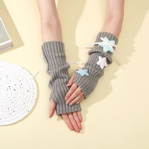Detail of grey knitted arm warmers with plush stars and cute bow decorations