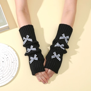 Close-up of black ribbed knit fingerless gloves with three blue striped ribbon bows